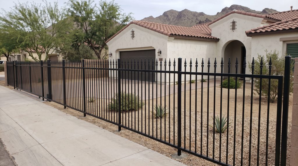 Black spear top steel fence in front of a Spanish-style home in Phoenix, Arizona